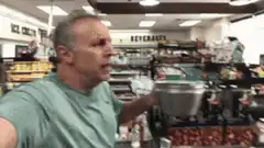 Man holding metal bowl in grocery store