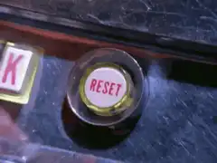 Finger pressing reset button
