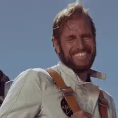 Man in white suit laughing hysterically