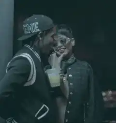 Travis Scott and Rihanna sharing a drink