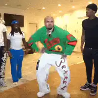 Bald man in green sweater dancing