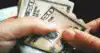 hands counting dollar bills