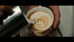 barista pouring latte art
