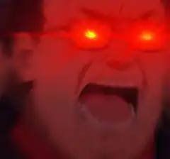 Man screaming with glowing red eyes
