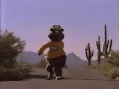 A&W Root Bear dancing on a desert road