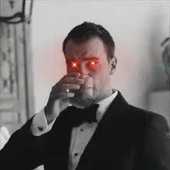 Man in tuxedo drinks and shoots laser beams from eyes