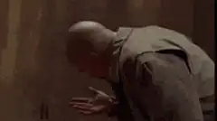 Bald man kicks and punches another man