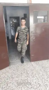 Soldier salutes after walking through door