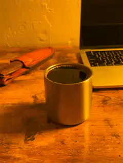 Coffee cup on desk with laptop