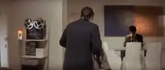 Man turns around holding coat