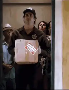 Delivery guy kicks box into apartment