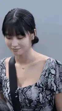 woman in snakeskin top smiling
