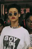 Rihanna wearing sunglasses and a BOY shirt