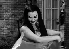 Morticia Addams twirling in black and white