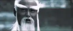 Old man with white beard gives thumbs up