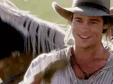 Brad Pitt smiling in a cowboy hat