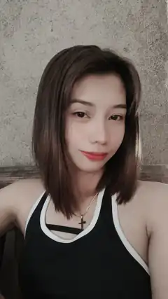 woman in black tank top smiling