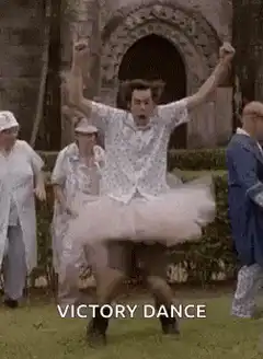 Man in tutu doing victory dance