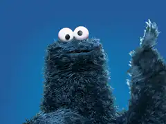 Cookie Monster waving and opening mouth