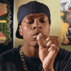 Man smoking a joint with smoke in his nose