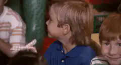 Kid makes ok sign with letter k