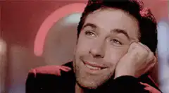 Hugh Jackman smirking with hand on face