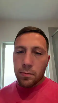 Man in pink shirt looking down