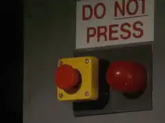 Red button next to do not press button