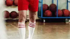 Man in red shorts and white socks dancing