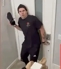 Man throws shoe at spider costume
