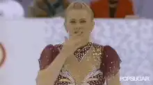 figure skater blows kiss and waves