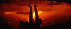 Batman hanging upside down in fire