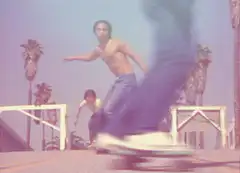 shirtless skateboarder doing a trick