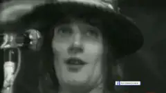 Freddie Mercury smiling and waving