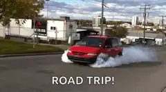 Red minivan doing a burnout with smoke
