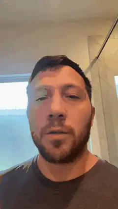 Man blinking and talking in bathroom