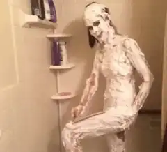 woman covered in shaving cream in shower