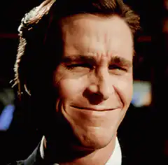 Christian Bale smirking and smiling