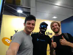 Three men posing at Bitcoin event