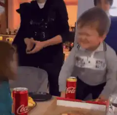 Crying toddler at pizza table