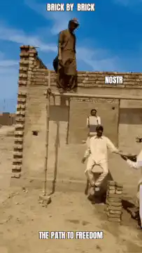 Man climbing wall as bricks are removed