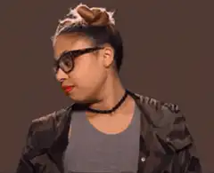 Woman with glasses tilts head