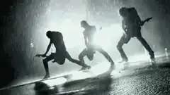 silhouetted band playing in rain