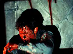 Bloodied man holding a bloody axe