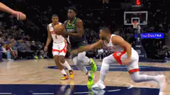 basketball player dunking over defender