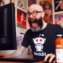 Man in Reddit shirt excited by computer