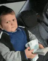 Baby counting money in car seat