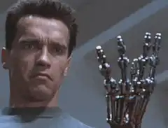 Arnold Schwarzenegger looks at the Terminator endoskeleton hand