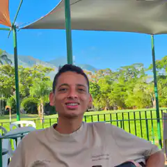 Man smiling under canopy with mountains