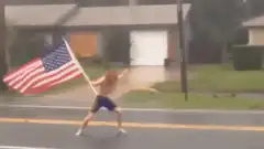 Man waving American flag in storm
